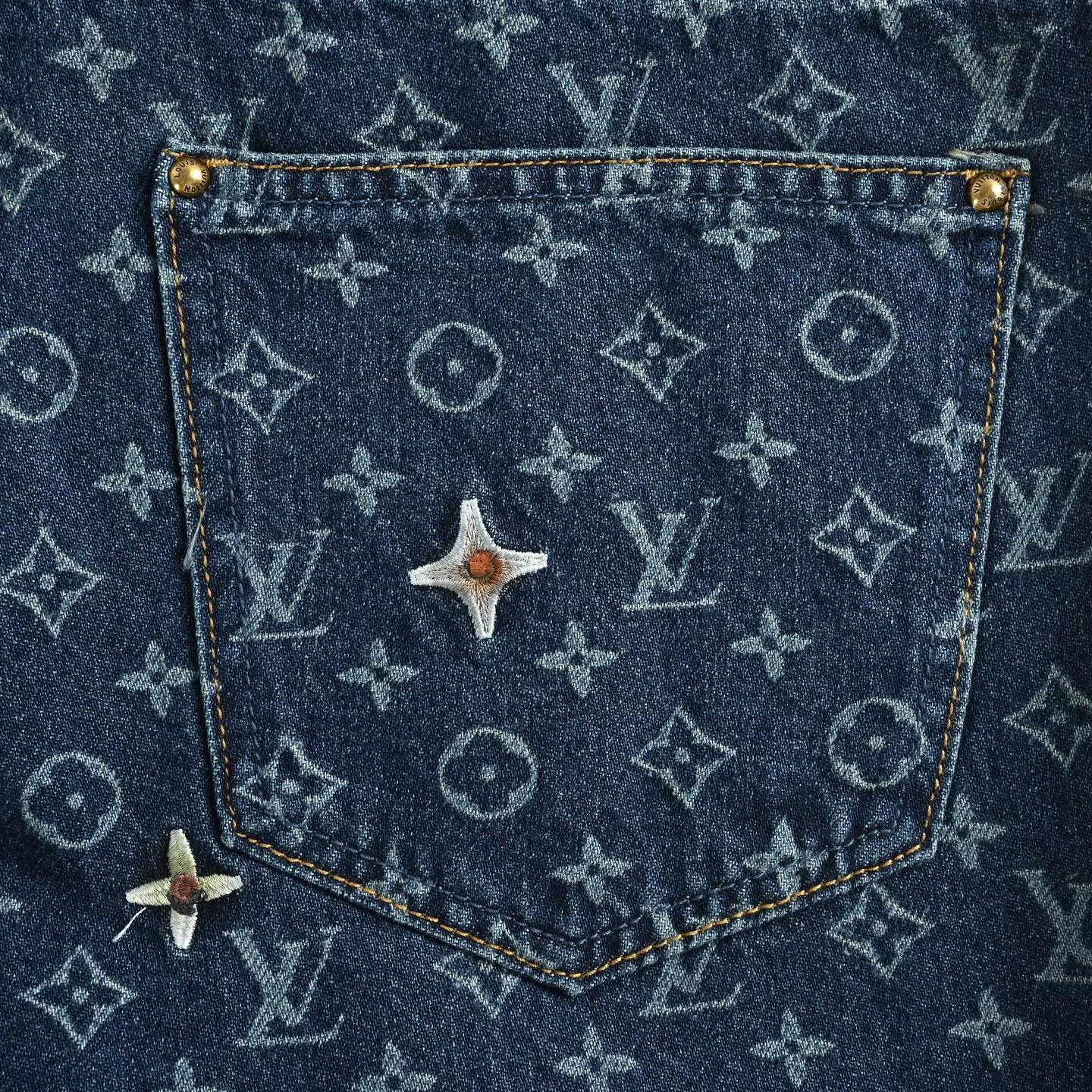 Louis Vuitton/Louis Vuitton all-over logo daisy embroidered jeans
